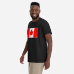 Front of Canada Flag black unisex garment-dyed heavyweight t-shirt on male model with large Canadian flag printed across chest.