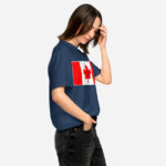 Front of Canada Flag navy unisex garment-dyed heavyweight t-shirt on female model with large Canadian flag printed across chest.