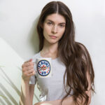Elbows Up In Canada Canadian Flag white ceramic 11oz mug held by female model showing 'Elbows Up In Canada' circle design.
