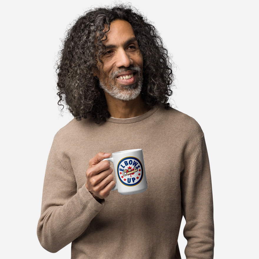 Elbows Up In Canada Canadian Flag white ceramic 15oz mug held by male model showing 'Elbows Up In Canada' circle design.