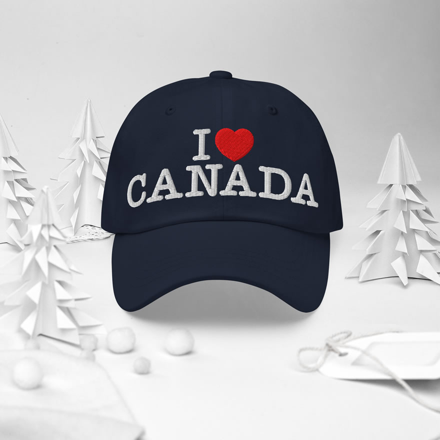 Front of I Love Canada navy classic dad hat in white forest scene showing words 'I Love Canada' embroidered white with red heart for the word 'love'.
