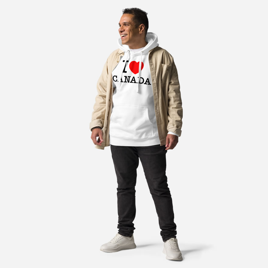 Front of I Love Canada white unisex premium hoodie on male model showing large Canadian flag printed across chest.