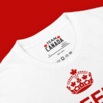 Close-up of top of Keep Calm And Canada On white unisex basic softstyle t-shirt showing inside label & crown w/ maple leafs.