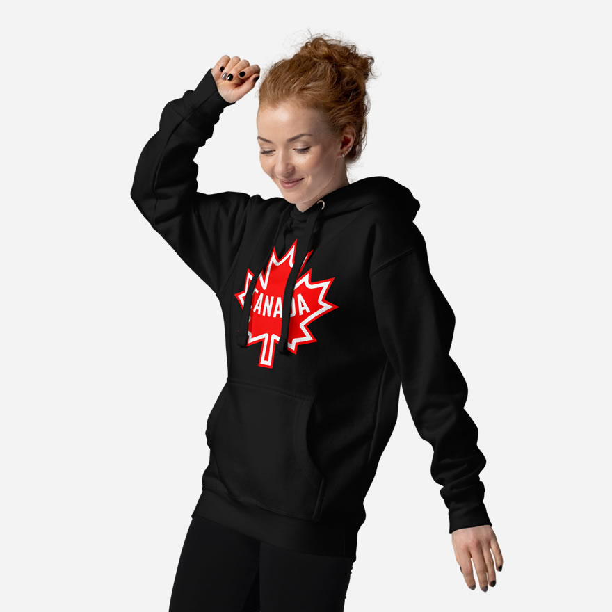 Front of Canada black unisex premium hoodie by Team Canada on female model showing large red & white Maple Leaf print across chest.