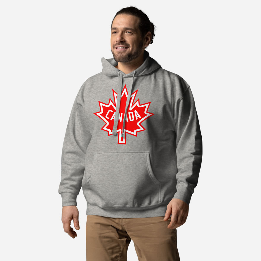 Front of Canada Flag carbon grey unisex premium hoodie by Team Canada on male model showing large red & white Maple Leaf print across chest.