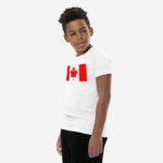 Front of Canada Flag white unisex youth staple t-shirt on boy model showing large Canadian flag print.