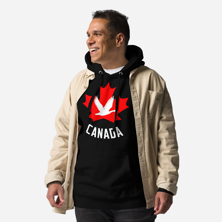 Front of Canada Goose black unisex premium hoodie on male showing maple leaf & goose print with Canada written below.