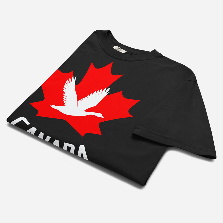 Front of Canada Goose black unisex heavyweight t-shirt folded up with maple leaf & goose print. Canada written below.