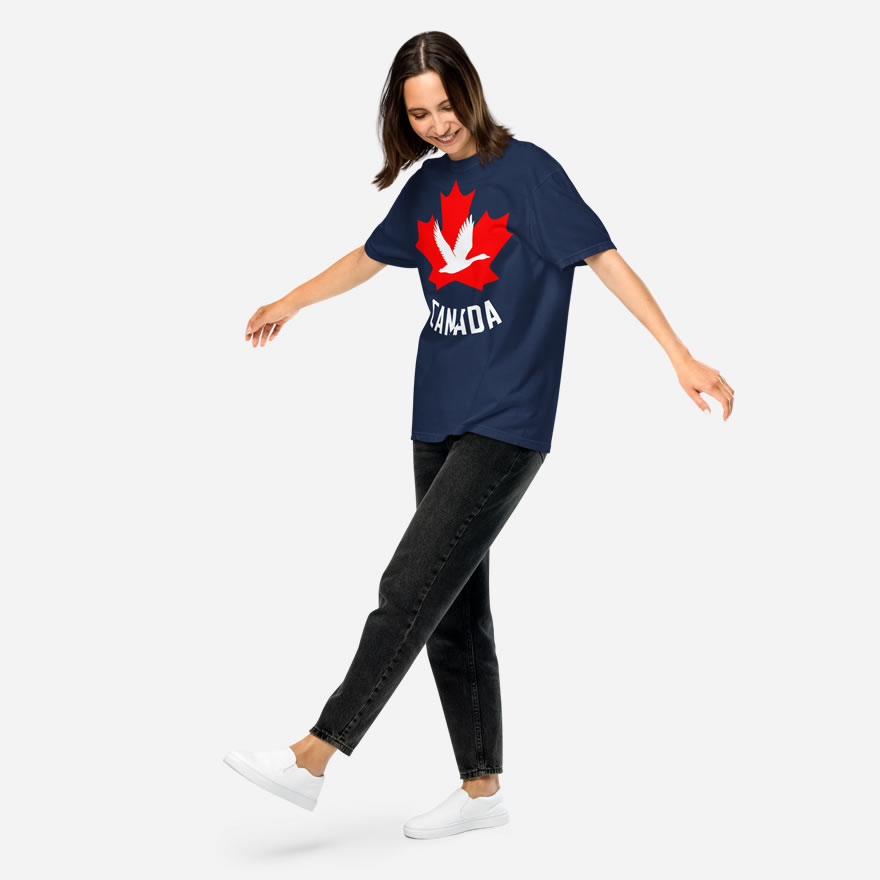 Front of Canada Goose navy unisex heavyweight t-shirt on girl showing maple leaf & goose print. Canada written below.