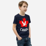 Front of Canada Goose navy unisex youth staple t-shirt on boy showing maple leaf & goose print. Canada written below.