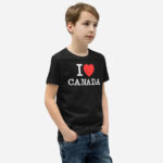 Front of I Love Canada black unisex youth staple t-shirt on boy model showing 'I Love (heart) Canada' design.