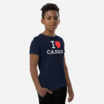 Front of I Love Canada navy unisex youth staple t-shirt on boy model showing 'I Love (heart) Canada' design.