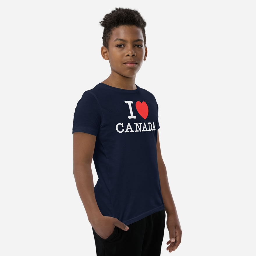 Front of I Love Canada navy unisex youth staple t-shirt on boy model showing 'I Love (heart) Canada' design.