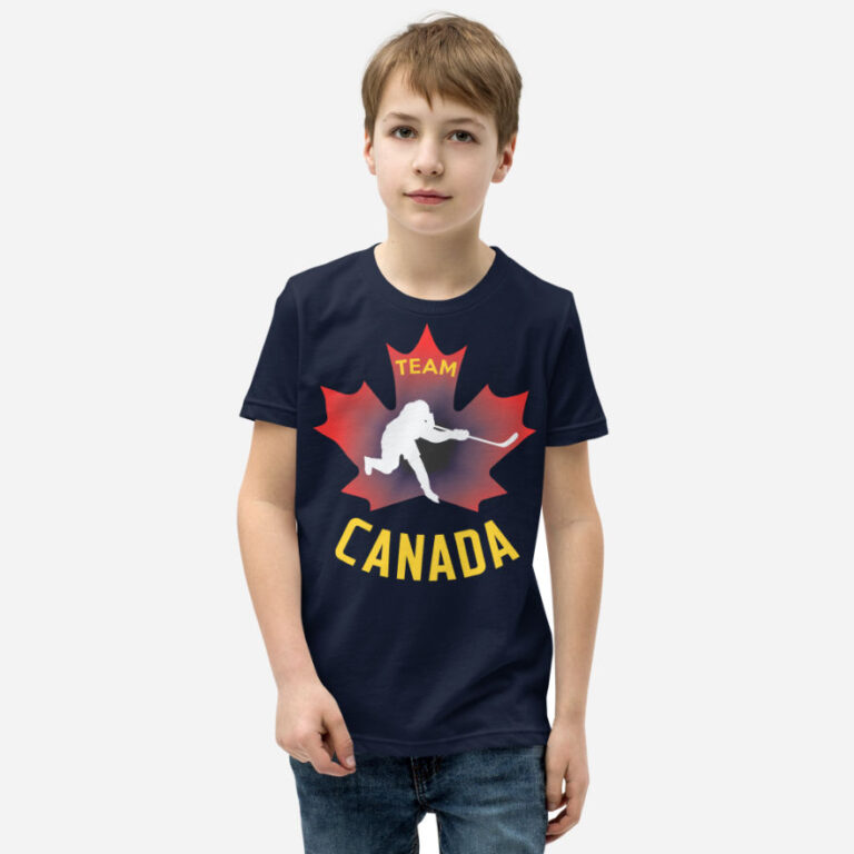 Front of Team Canada Hockey t-shirt navy unisex youth staple tee on boy. Hockey player slap shot figure on red maple leaf.