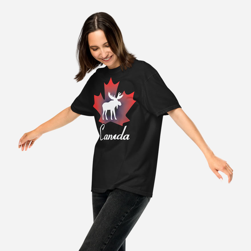 Front of Canada Moose black unisex garment-dyed heavyweight t-shirt on girl showing maple leaf & moose print. Canada written below.