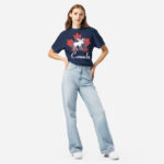 Front of Canada Moose navy unisex heavyweight t-shirt on girl showing maple leaf & moose print. Canada written below.