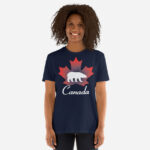 Front of Canada Polar Bear navy unisex softstyle t-shirt on female model with maple leaf & Polar Bear print. Canada written below.