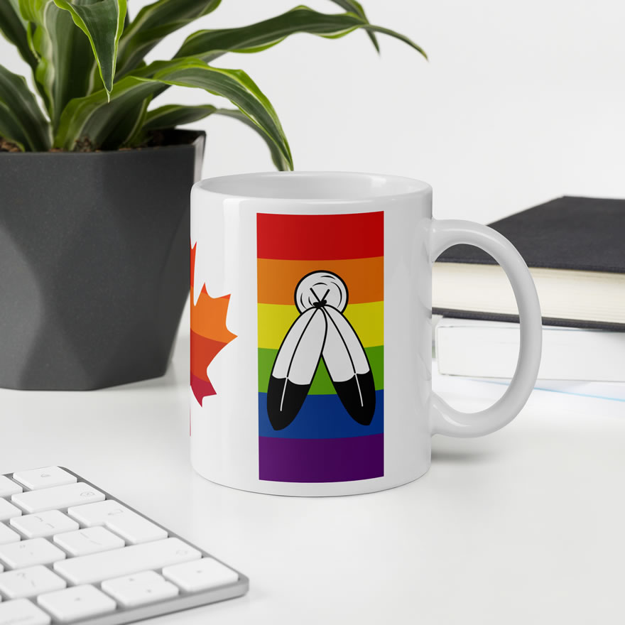 Canada Two-Spirit Intersex-Inclusive Progress Pride Flag white 11oz mug. Handle on right on office desk. Flag has Two-Spirit Pride stripes and feathers for right bar.