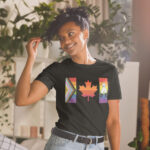 Front of Canada Two-Spirit Intersex-Inclusive Progress Pride Flag t-shirt black unisex softstyle tee on model. Flag has pride stripes for bars & maple leaf.