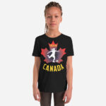 Front of Girl's Soccer black youth staple t-shirt on girl. Player kicking ball silhouette on red maple leaf. Says Team Canada.
