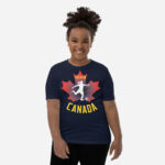 Front of Girl's Soccer navy youth staple t-shirt on girl. Player kicking ball silhouette on red maple leaf. Says Team Canada.