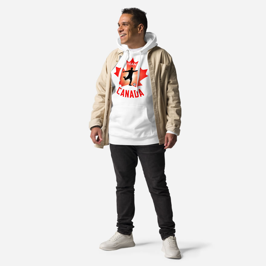Front of Men's Soccer white premium hoodie on man. Player kicking ball silhouette on maple leaf. Says Team Canada.