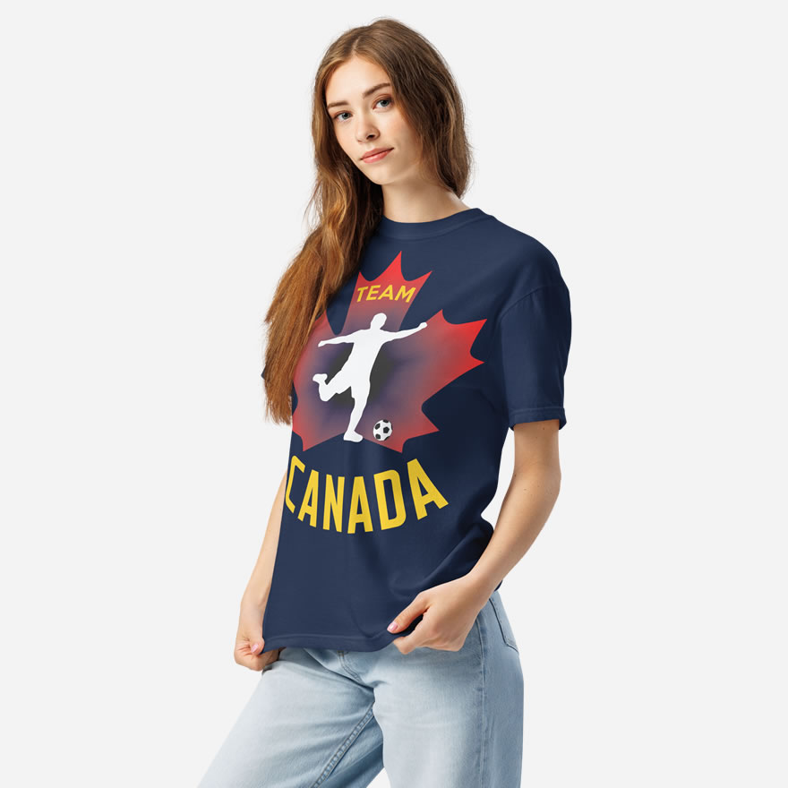 Front of Men's Soccer true navy heavyweight tee on woman. Player kicking ball silhouette on red maple leaf. Says Team Canada.