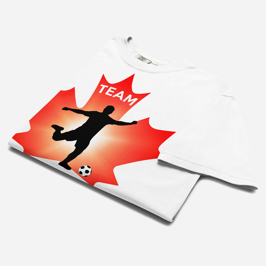 Folded Men's Soccer white heavyweight t-shirt. Player kicking ball silhouette on red maple leaf. Says Team Canada.