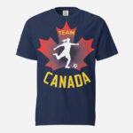 Front of Women's Soccer true navy unisex heavyweight tee. Player kicking ball silhouette on red maple leaf. Says Team Canada.