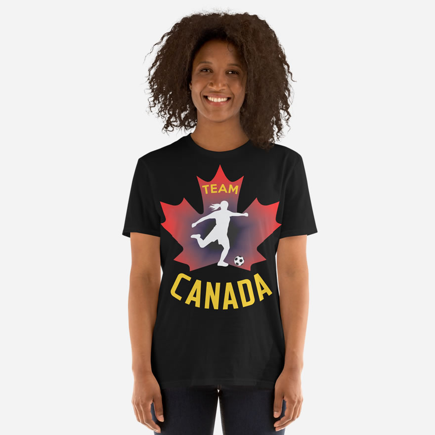 Front of Women's Soccer black unisex t-shirt on woman. Player kicking ball silhouette on maple leaf. Tee says Team Canada.