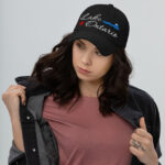 Front of Lake Ontario black classic dad hat on model showing 'Lake Ontario' embroidered white along with red maple leaf & blue wave.
