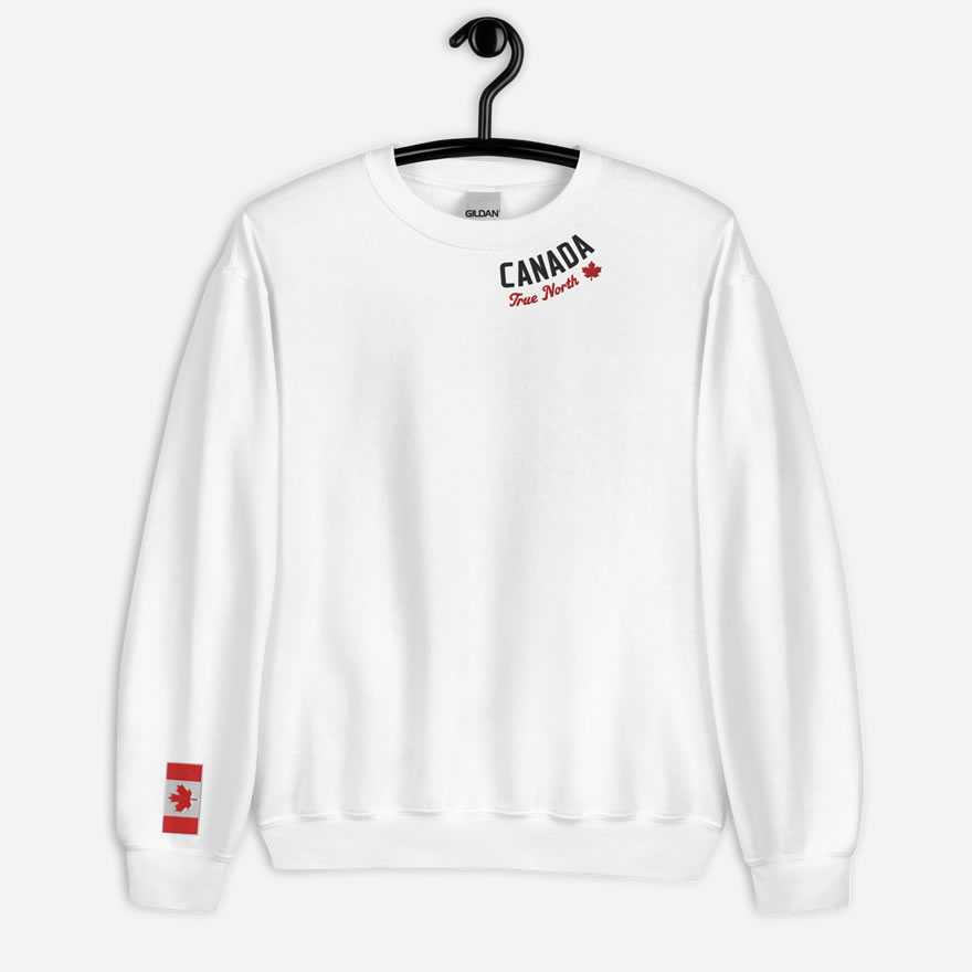 Front of white Canada True North sweatshirt embroidered in white, red with red maple leaf curved along neckline. Flag on right wrist.