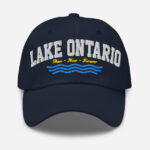 Front of Lake Ontario Canada navy dad hat showing words 'Lake Ontario' atop wavy lines embroidered white above red maple leaves.