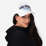 Front of Lake Ontario Canada white dad hat on model showing 'Lake Ontario' atop wavy lines embroidered navy with red maple leaves.