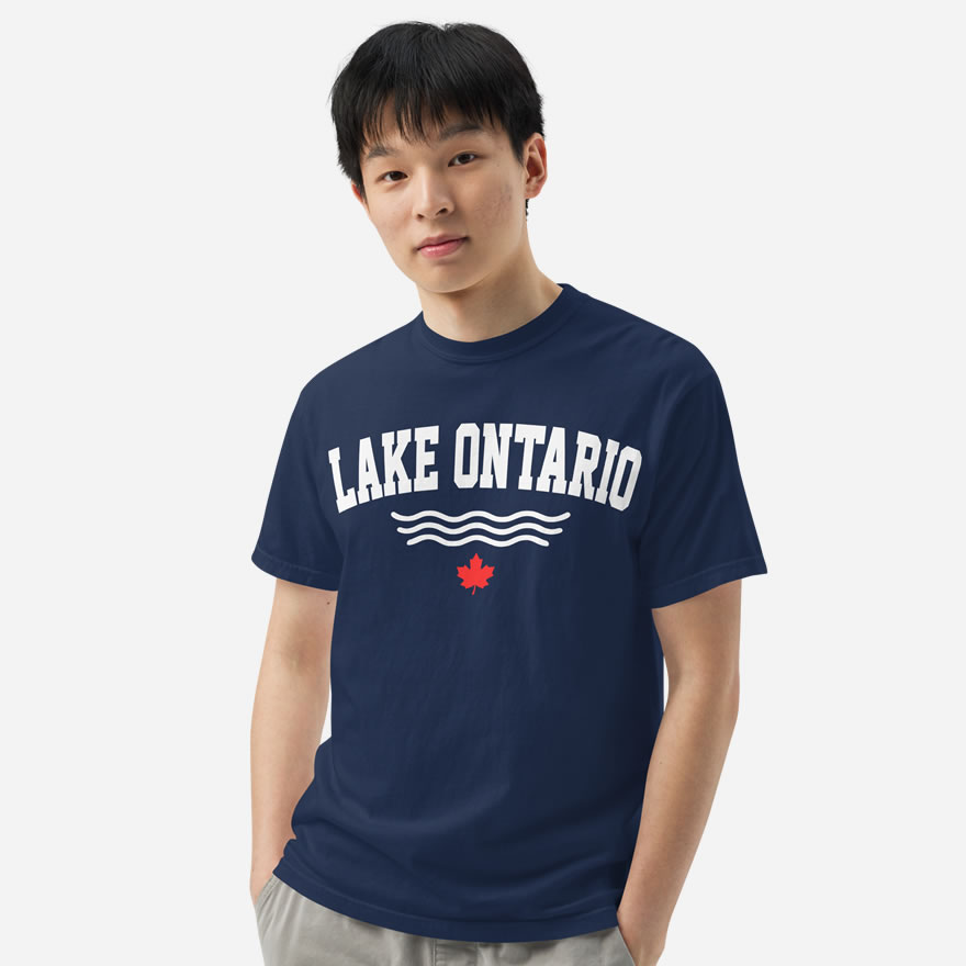 Front of Lake Ontario true navy heavyweight t-shirt on model with words Lake Ontario atop wavy lines (in white) above a red maple leaf.