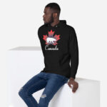 Front of Canada Polar Bear black unisex premium hoodie on female with maple leaf & Polar Bear print. Canada written below.
