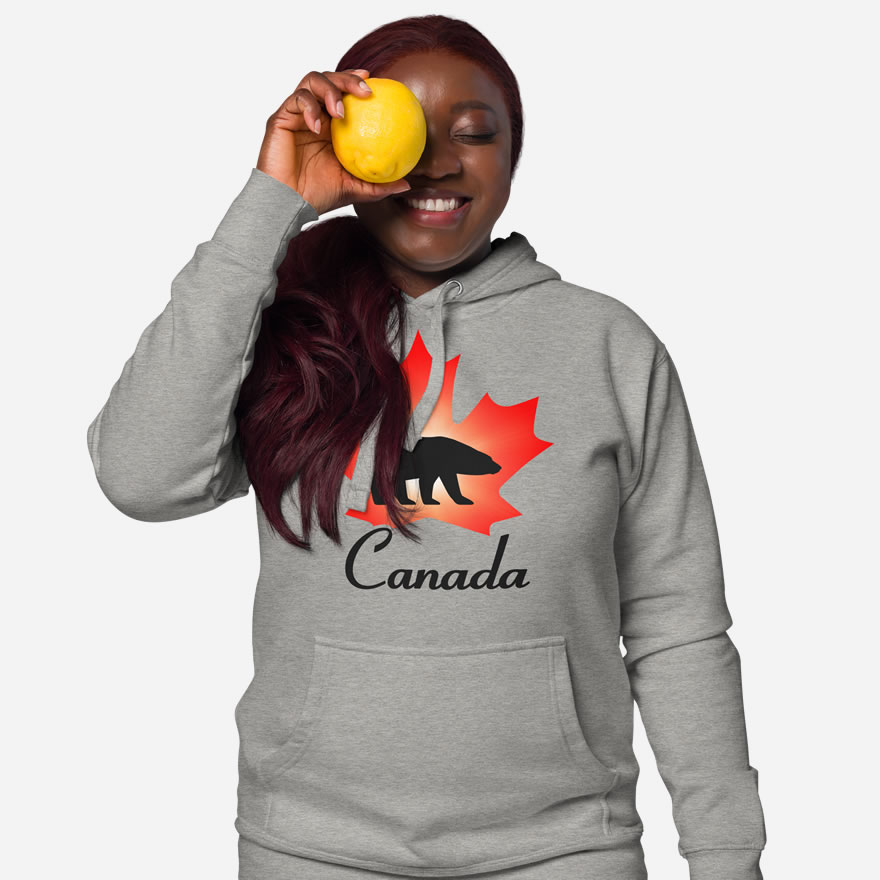 Front of Canada Polar Bear carbon grey unisex premium hoodie on female with maple leaf & Polar Bear print. Canada written below.